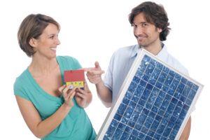 couple holding house and solar panel